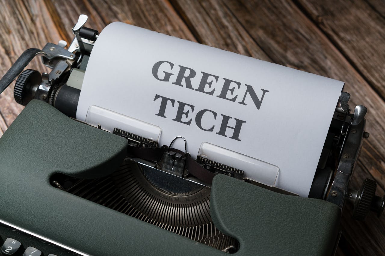 A top view of a vintage typewriter with 'Green Tech' typed on paper, symbolizing sustainable technology.